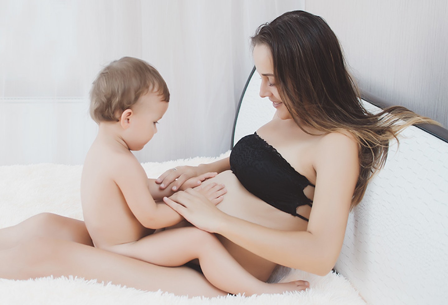 Baby checking movement of unborn sibling