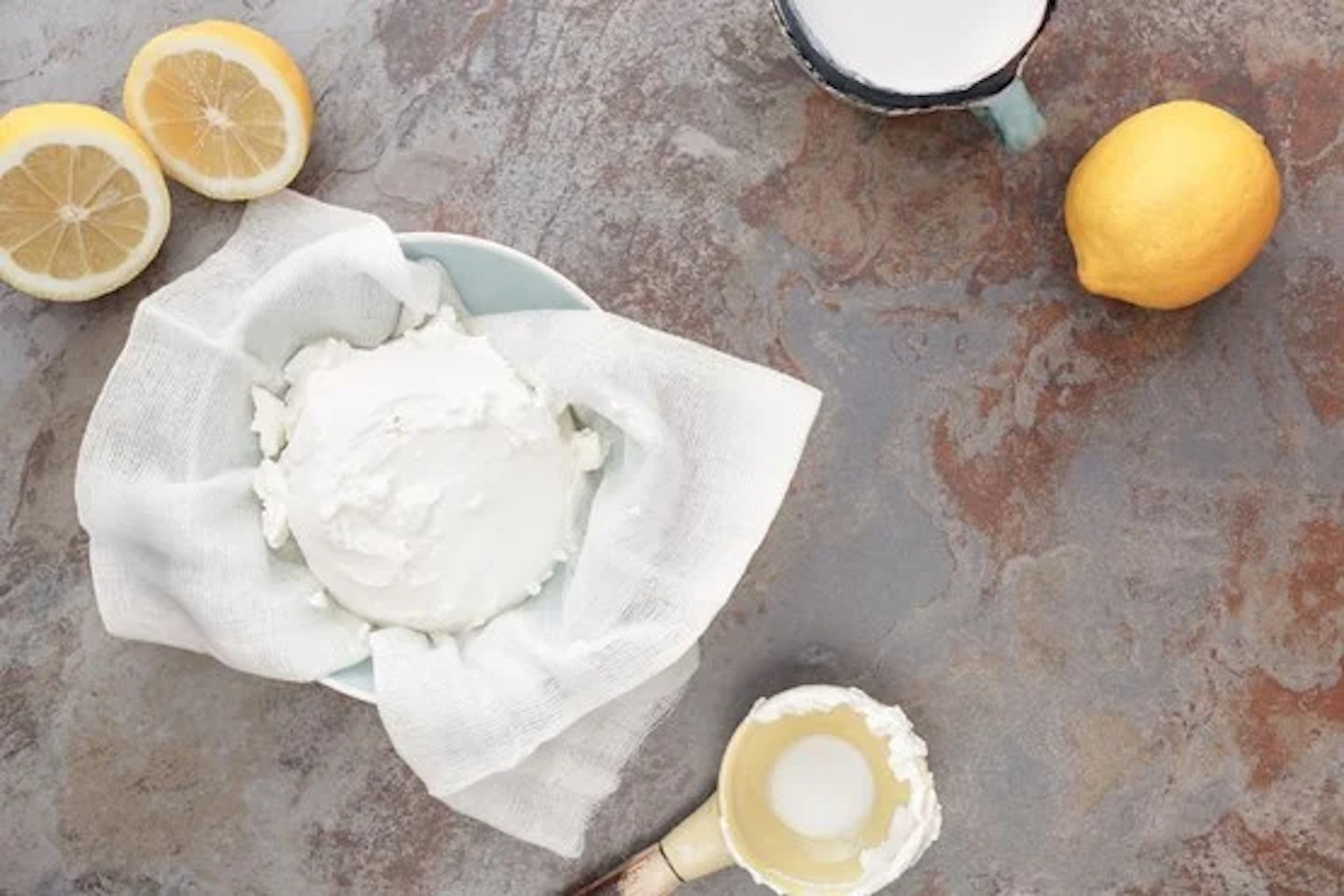Mascarpone in a bowl and lemons
