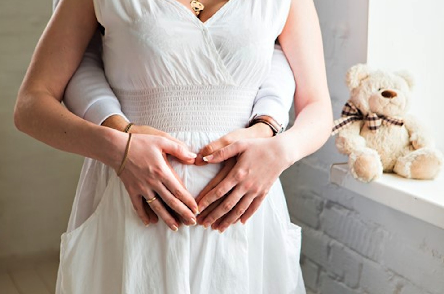 couple holding woman's stomach