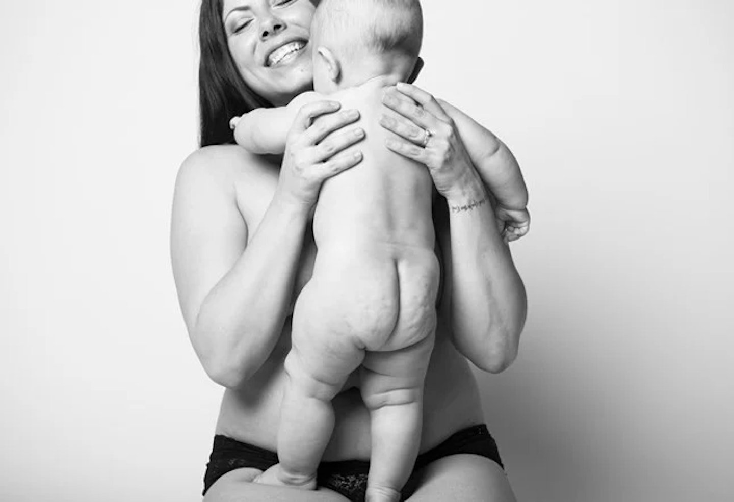 semi-nude mother and nude baby