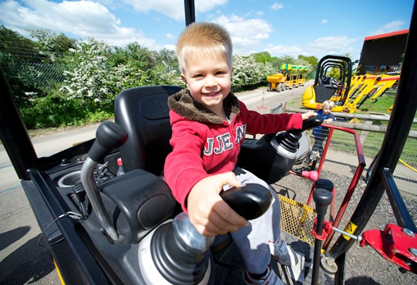 kid playing on toy digger