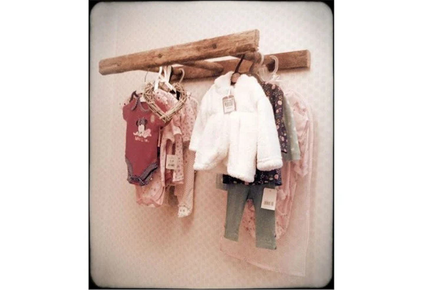 Ladder as a clothes rail with clothes hanging on