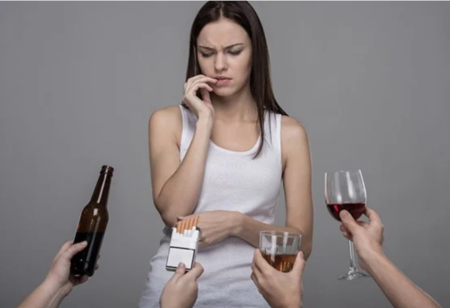 A woman being offered wine, beer and cigarettes