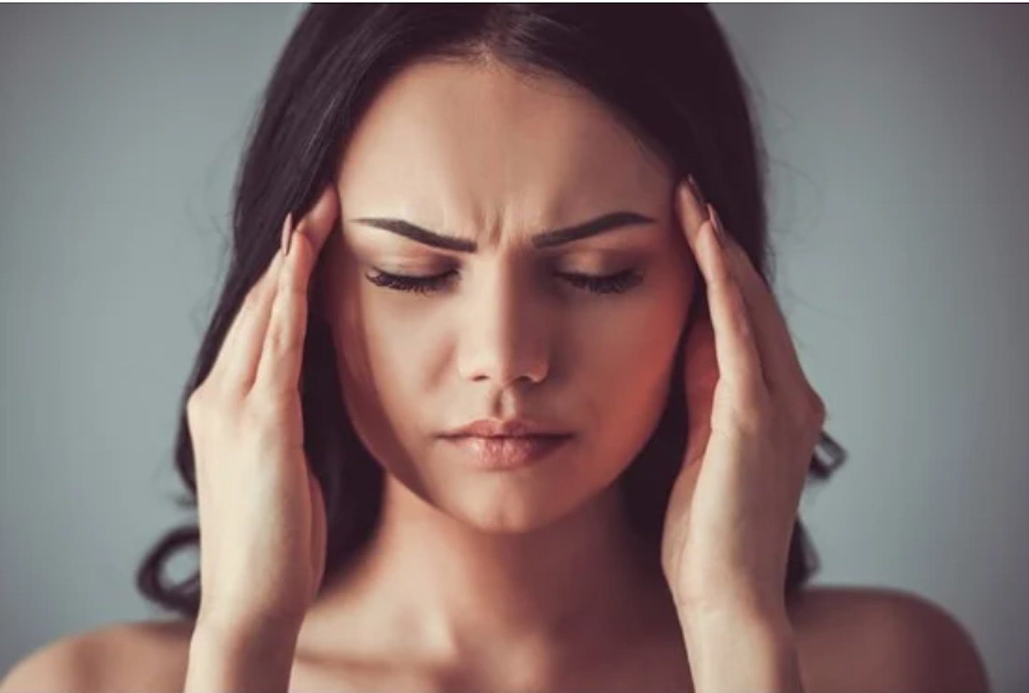 A woman holding her head