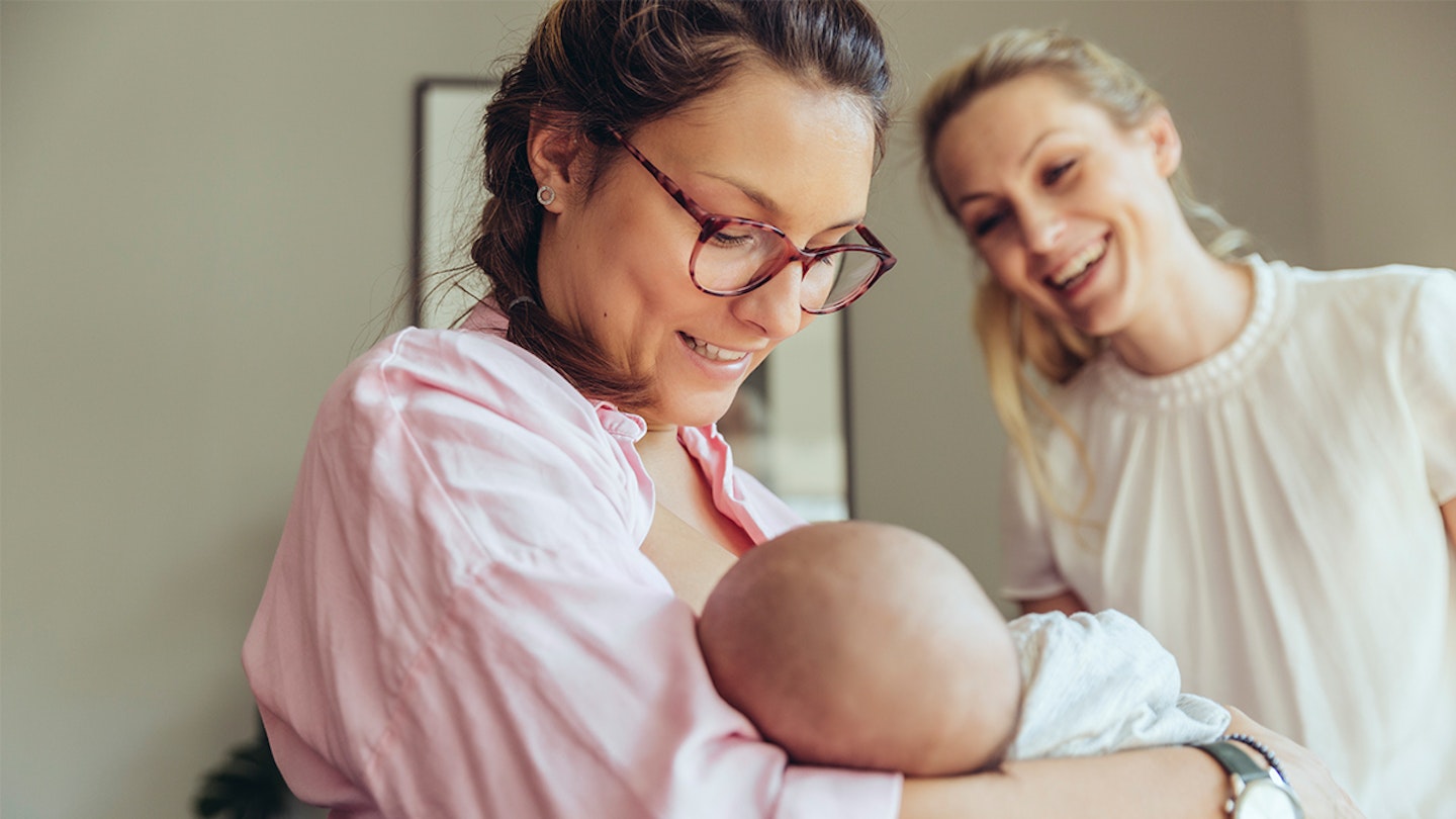 midwife helping breastfeeding mum