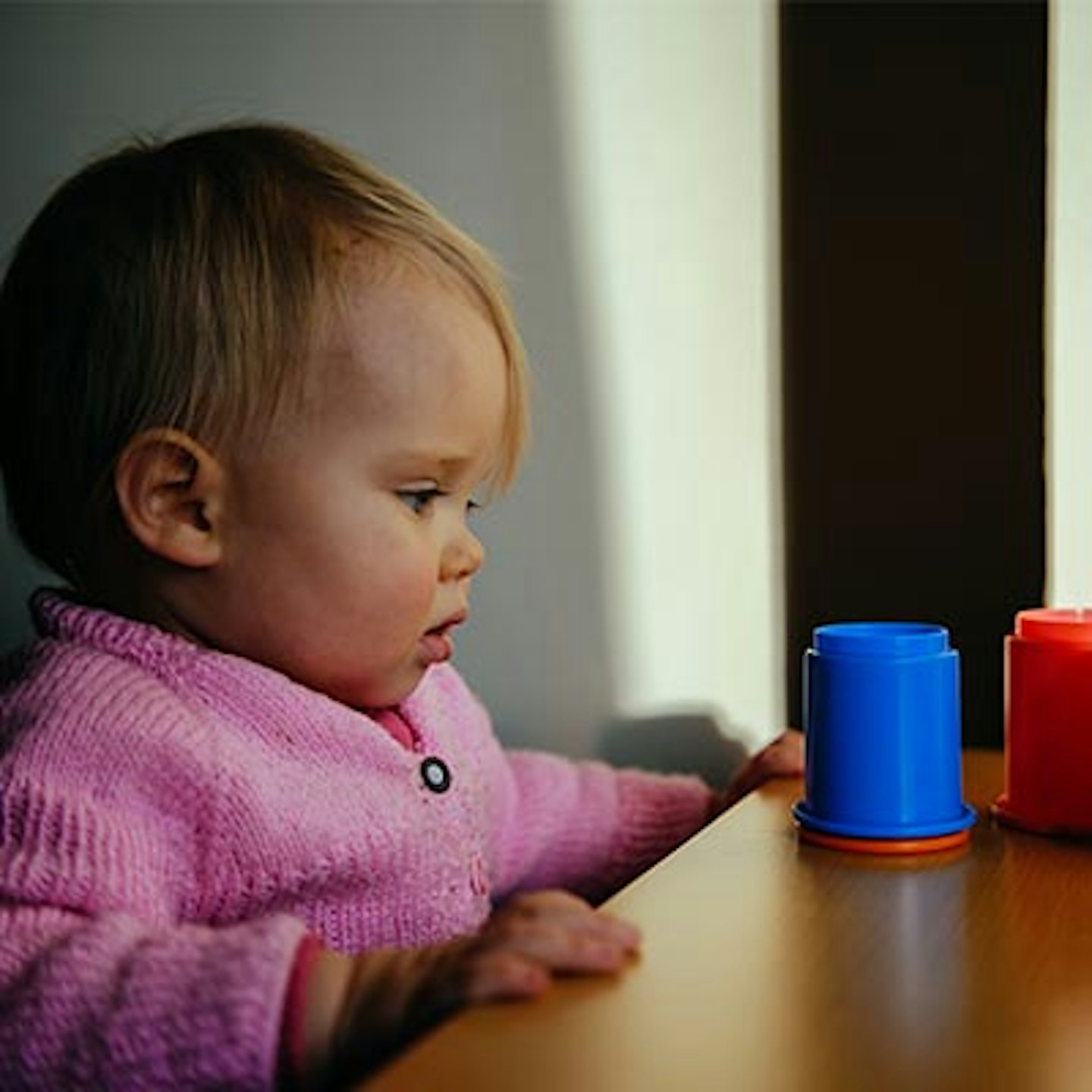 baby looking at cups