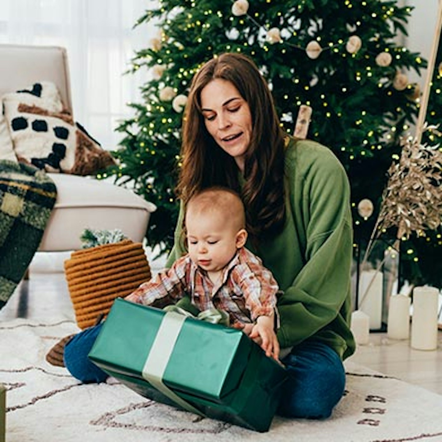 mum helping baby with present