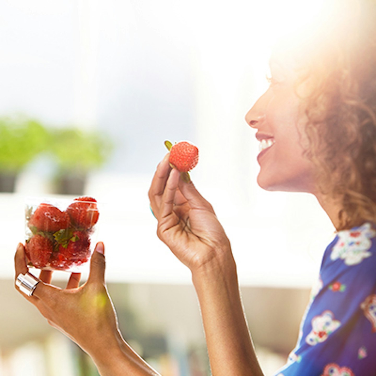 woman eating strawberries