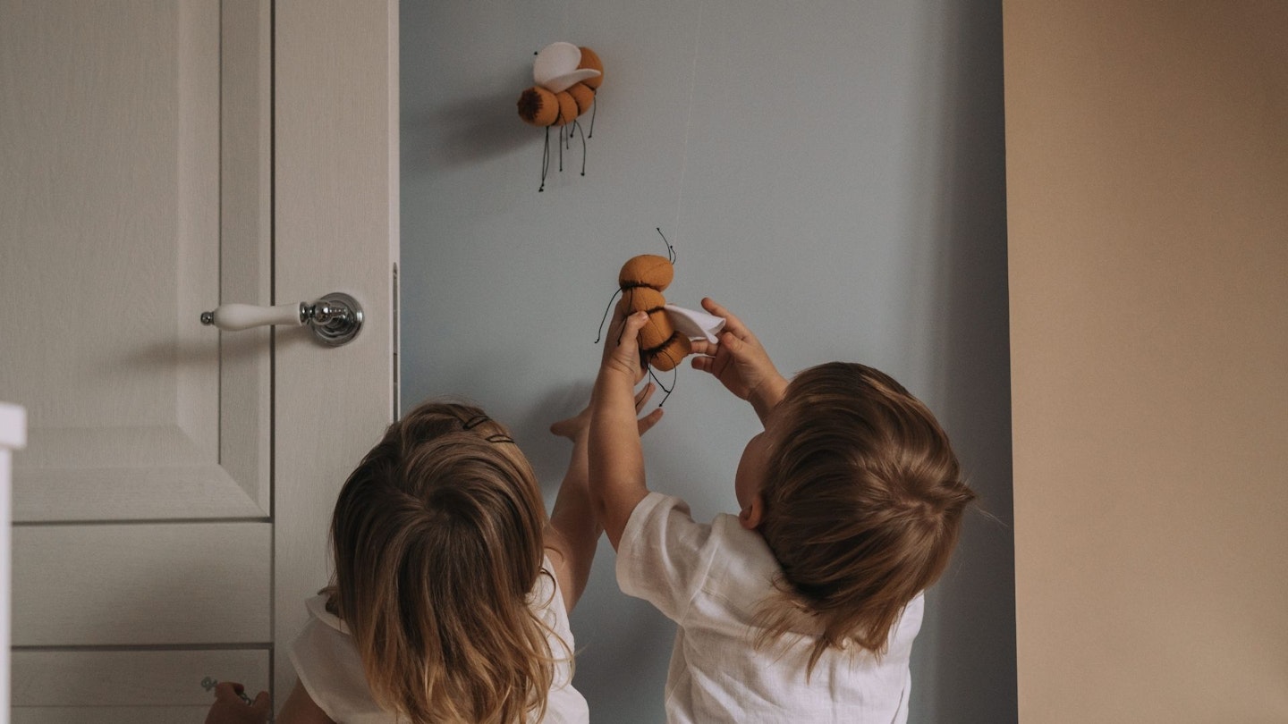 Toddler Twins Having Fun In The Room. Children Play In The Room