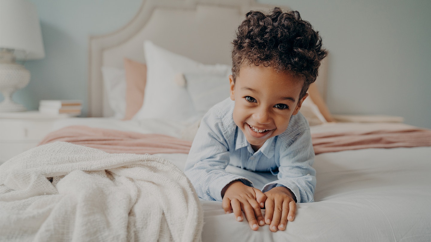 toddler-smiling-in-bed