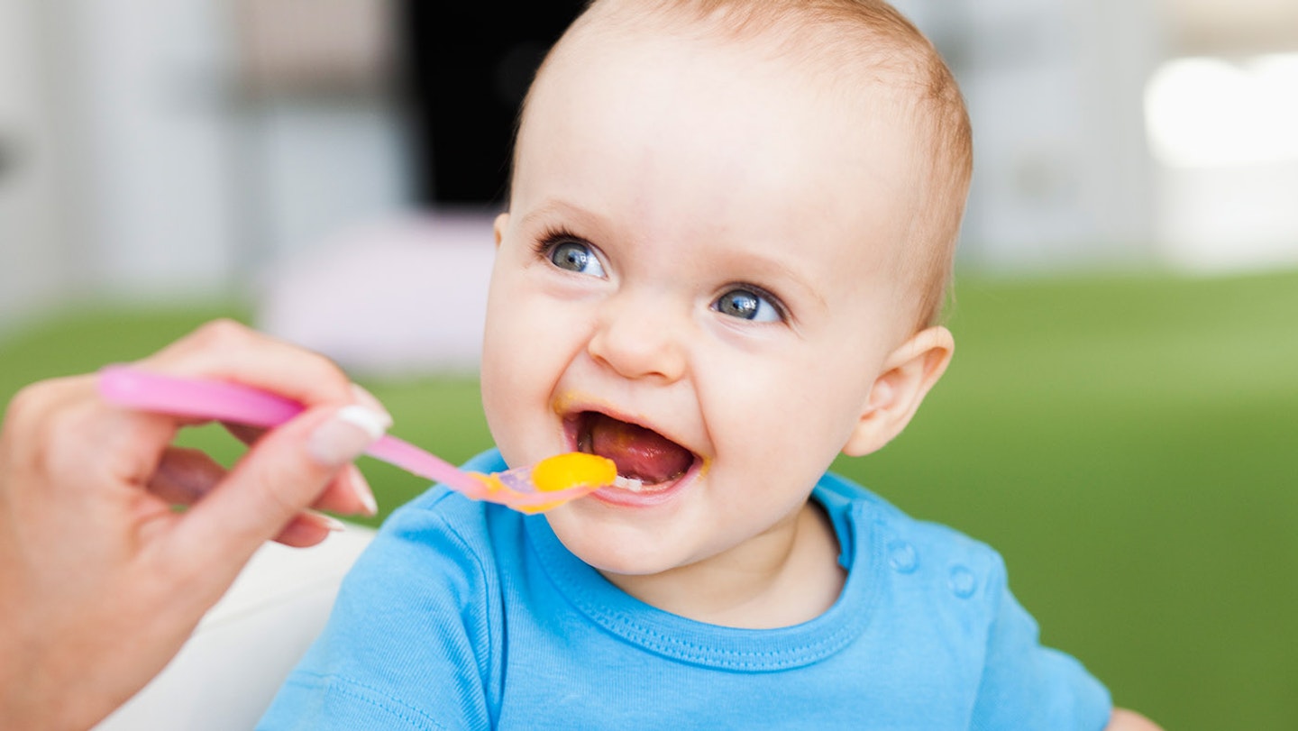 baby eating food containing iron