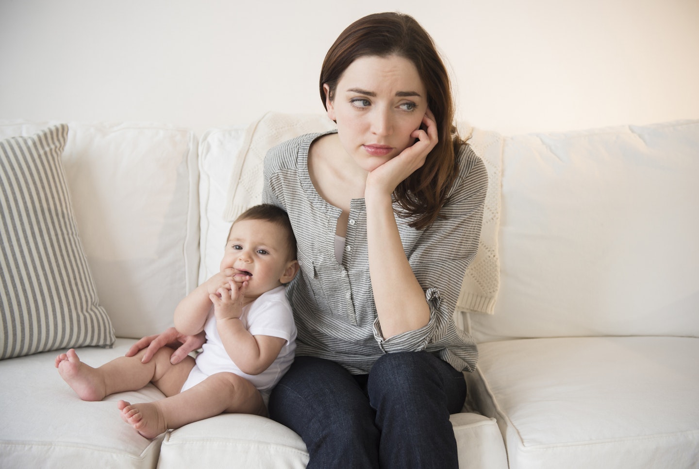 mum with new baby looking sad