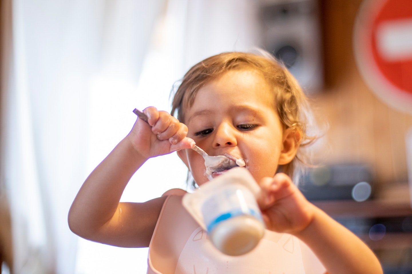 toddler eating yogurt