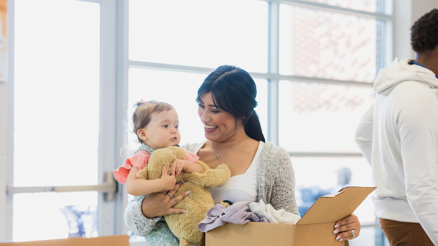 woman with little girl buying second-hand toy