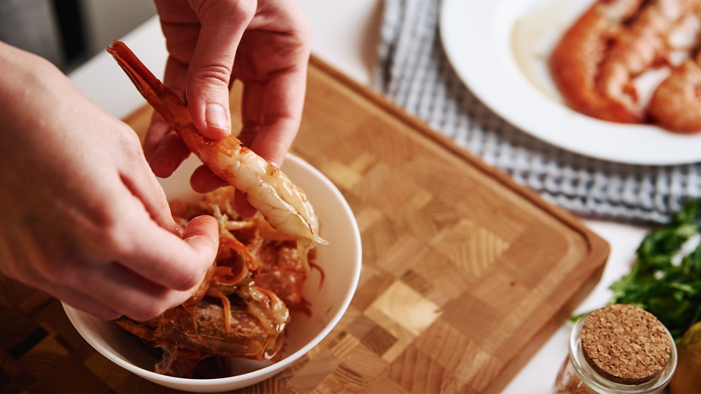 pregnant woman peeling prawns