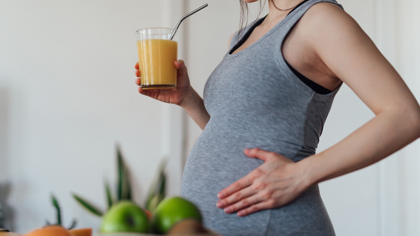 pregnant woman drinking a smoothie