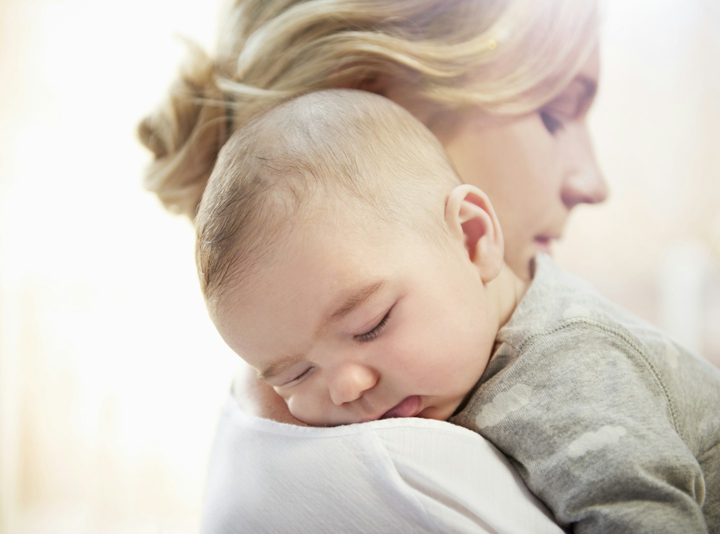 baby asleep on mum's shoulder