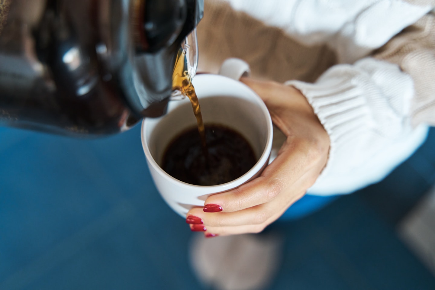 woman pouring herself coffee