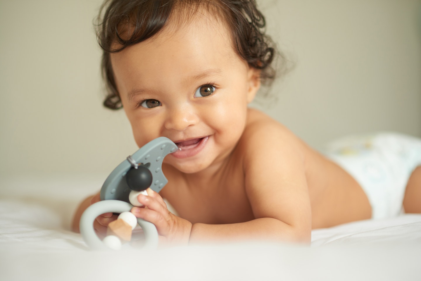 baby chewing on teething toy