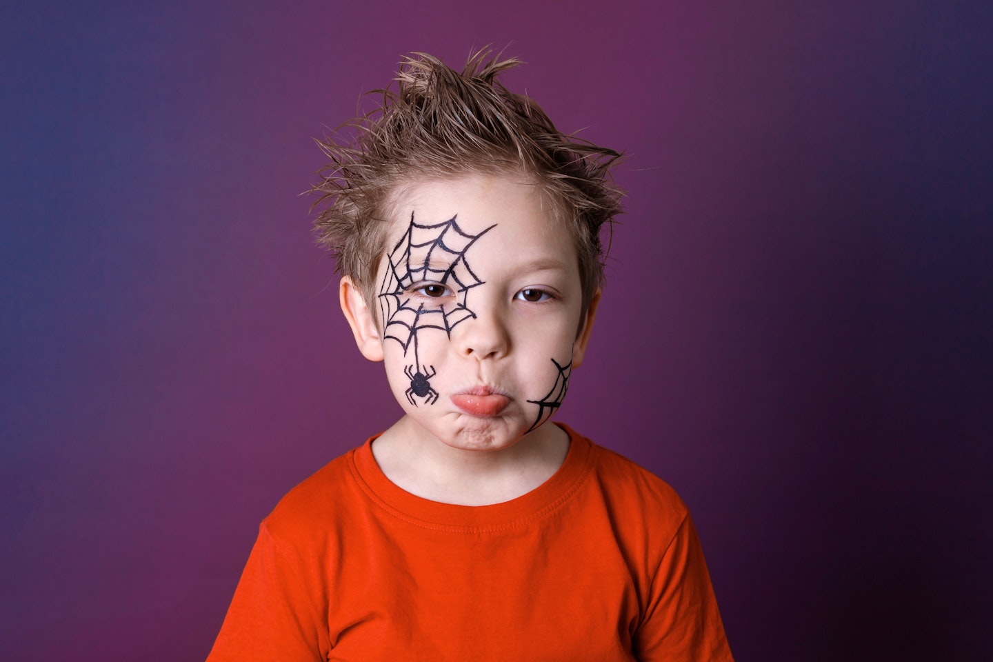 Cute little boy with Halloween makeup in gloomy emotions."nHalloween festive face painting concept.