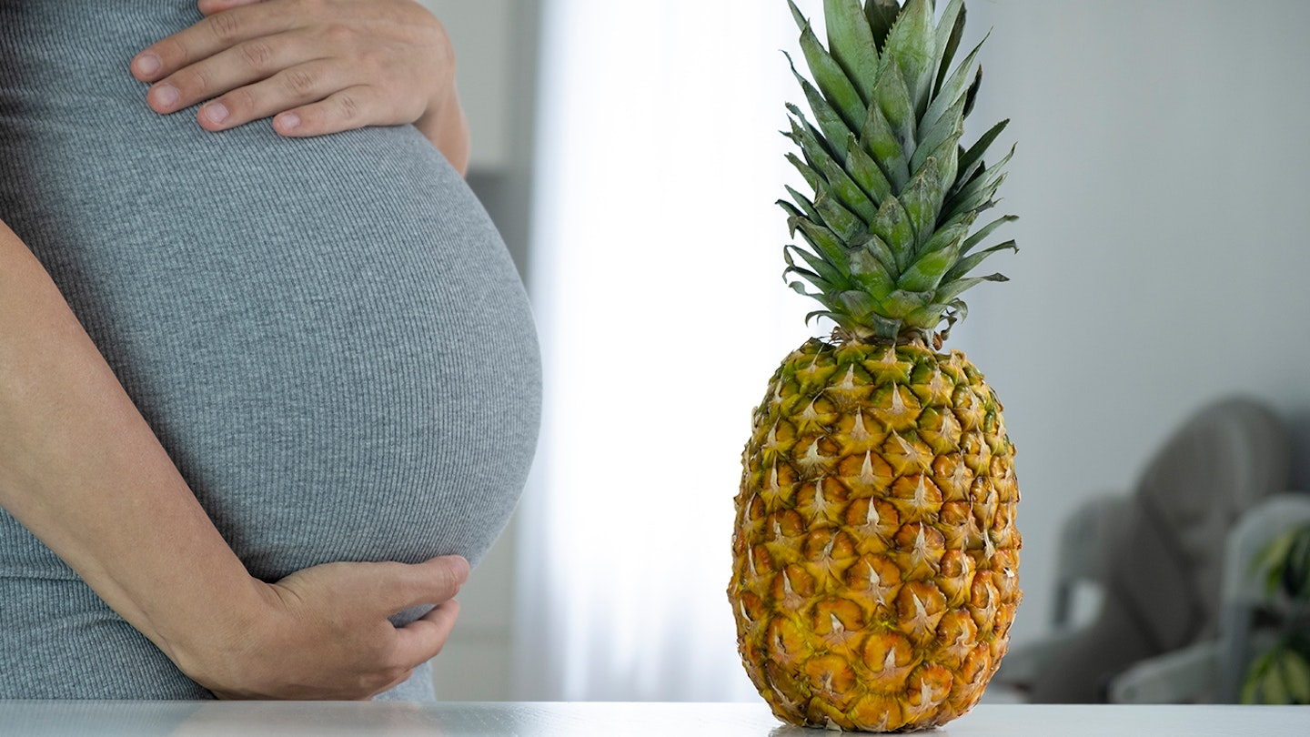 pregnant woman and a pineapple