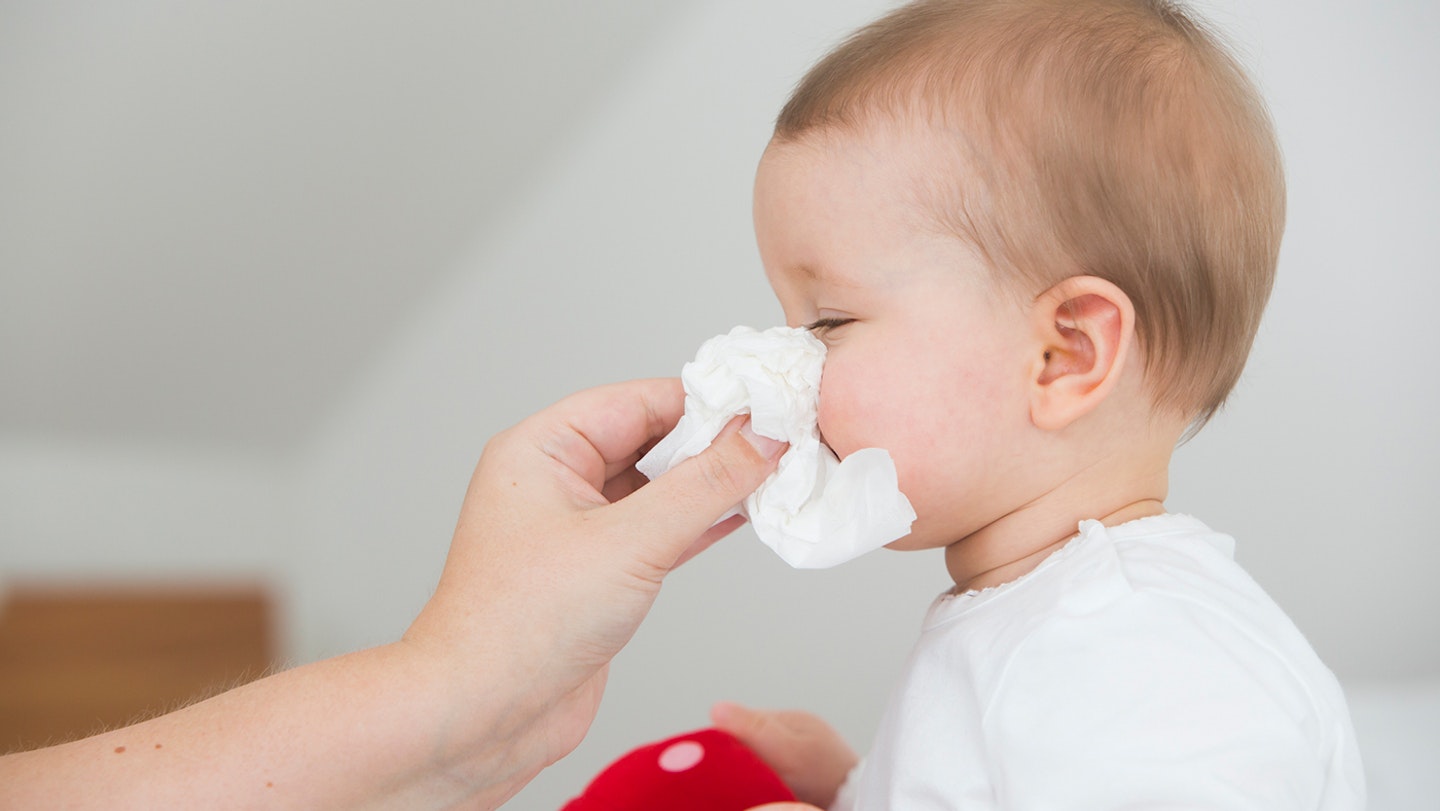 baby having its nose blown