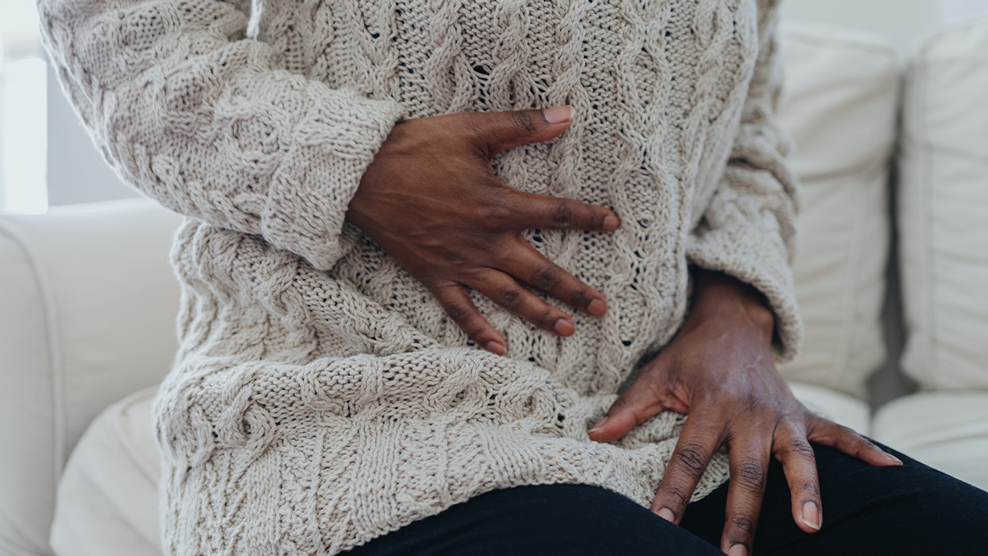 woman holding abdomen