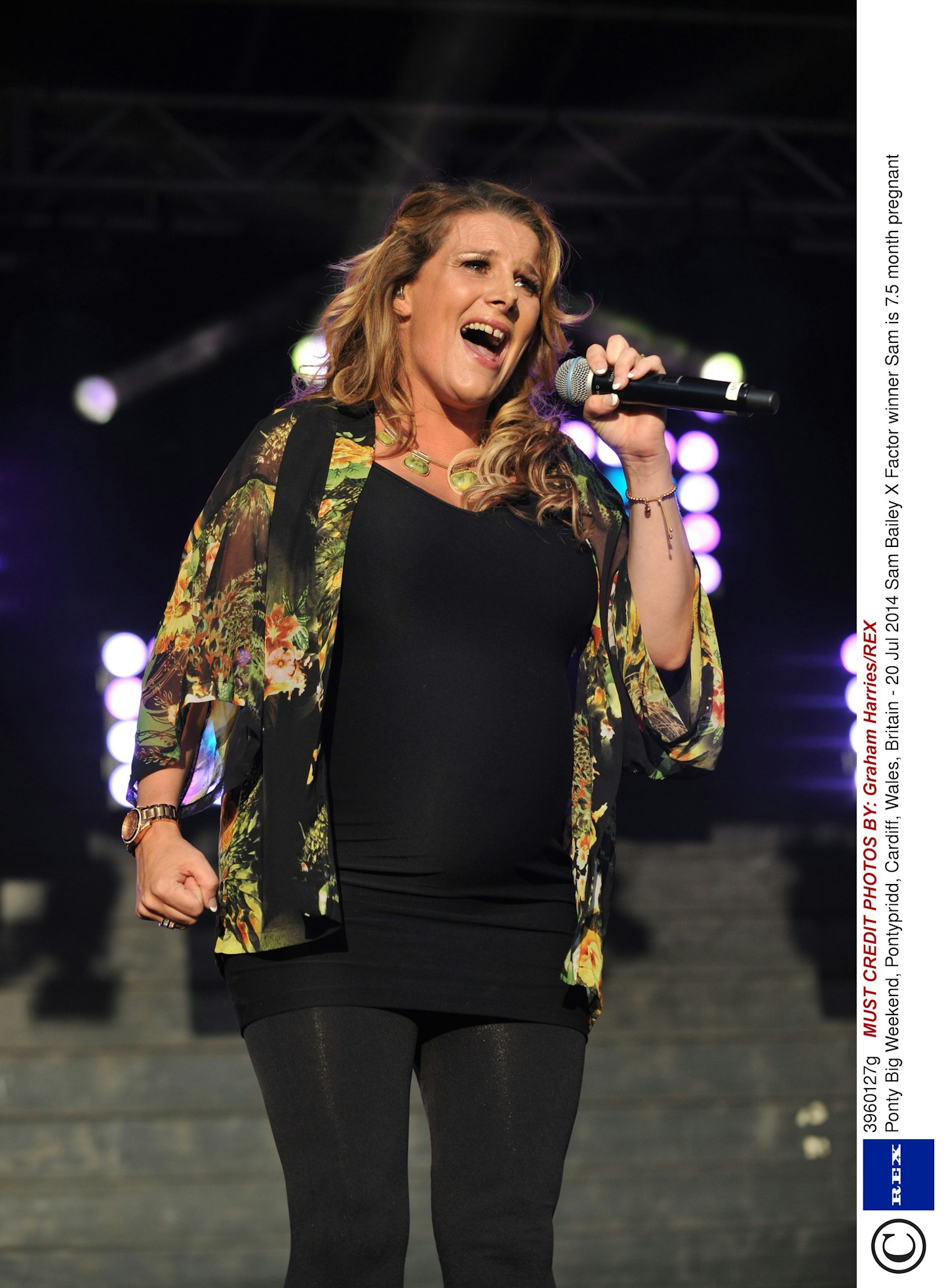 X Factor winner Sam ticks all the right boxes with this maternity stage outfit - LBD paired with a tropical print shirt and matching necklace. Beach meets black tie. 