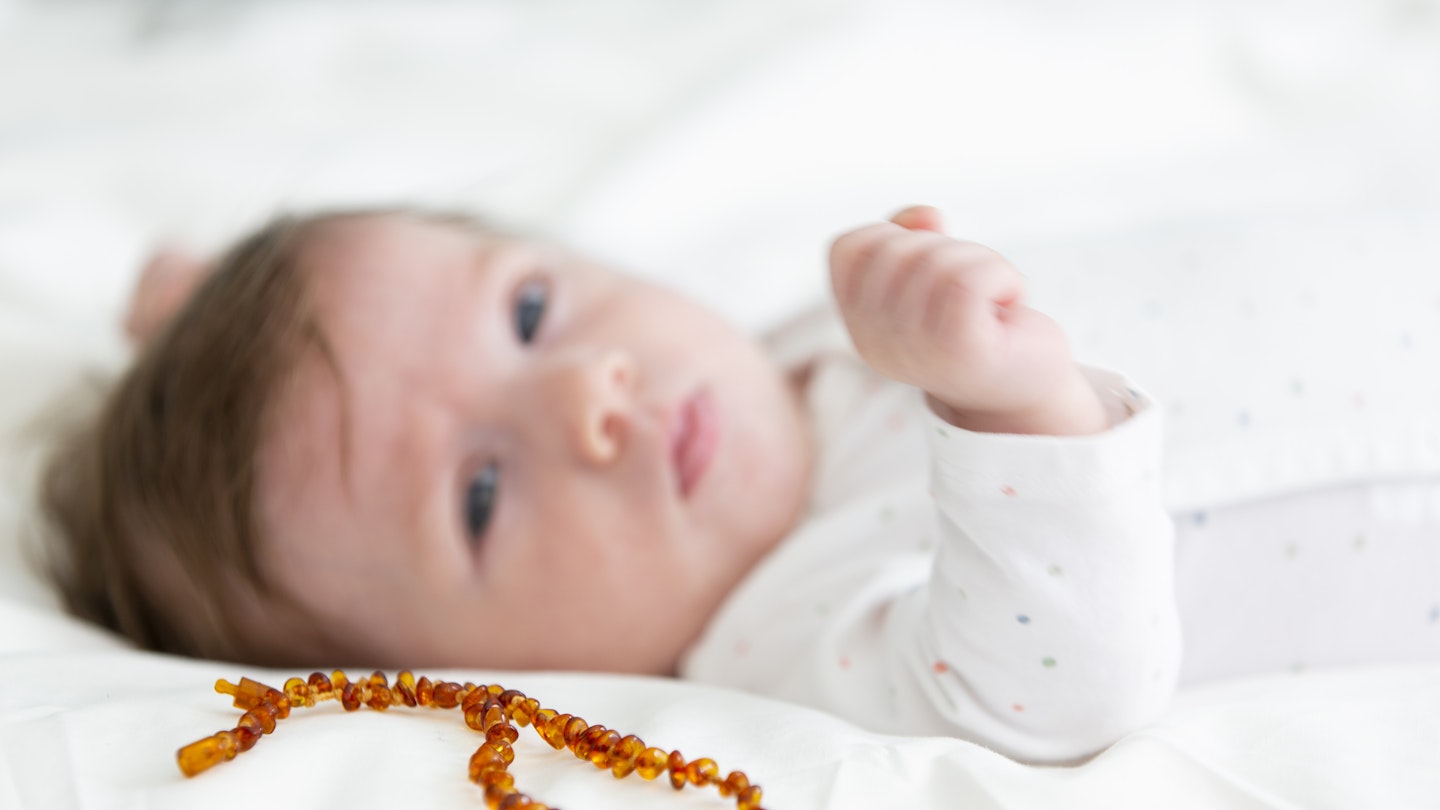 baby with amber teething necklace 