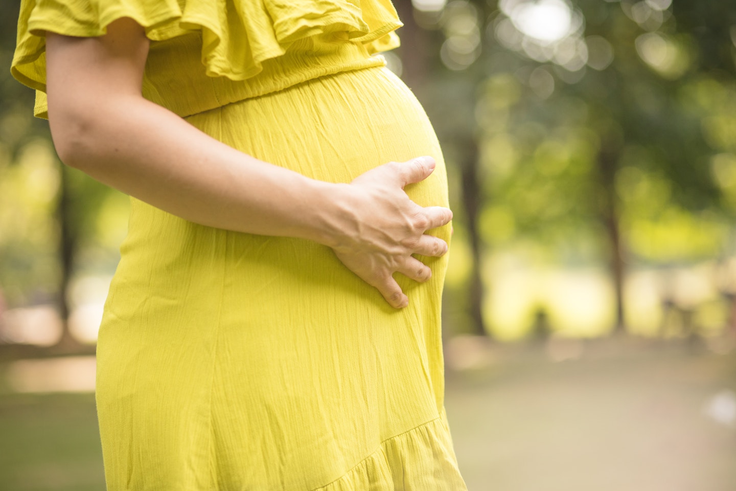 Pregnant woman holding her bump