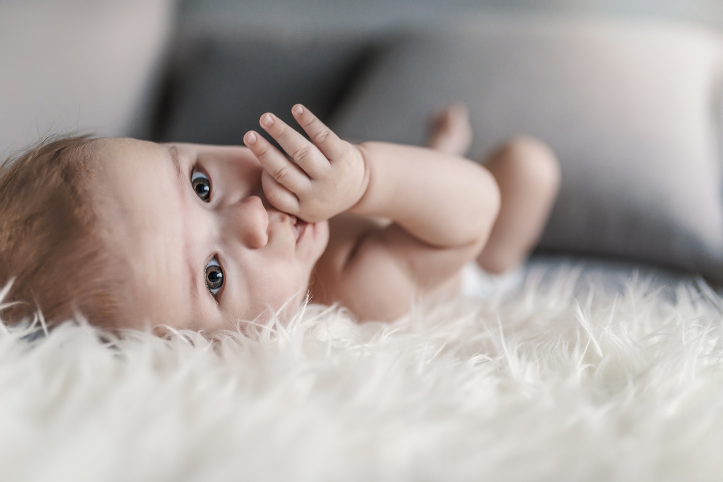 baby lying on a fuzzy rug