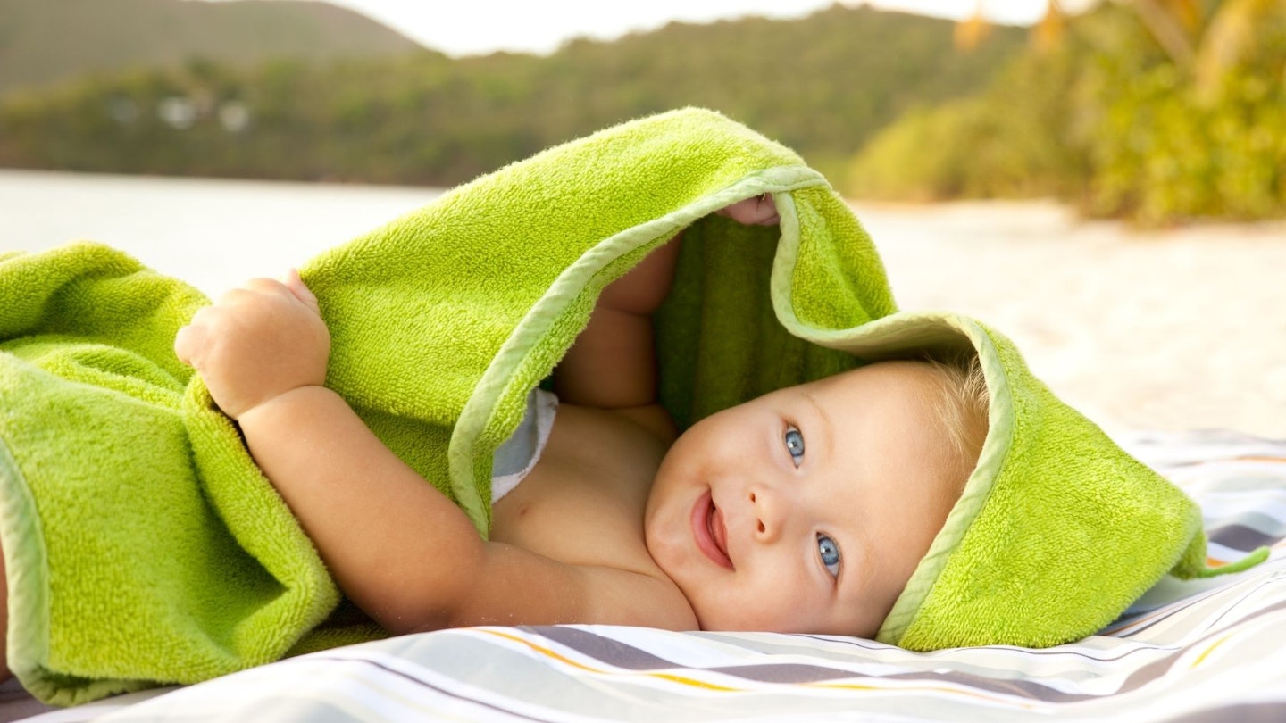 baby in beach towel