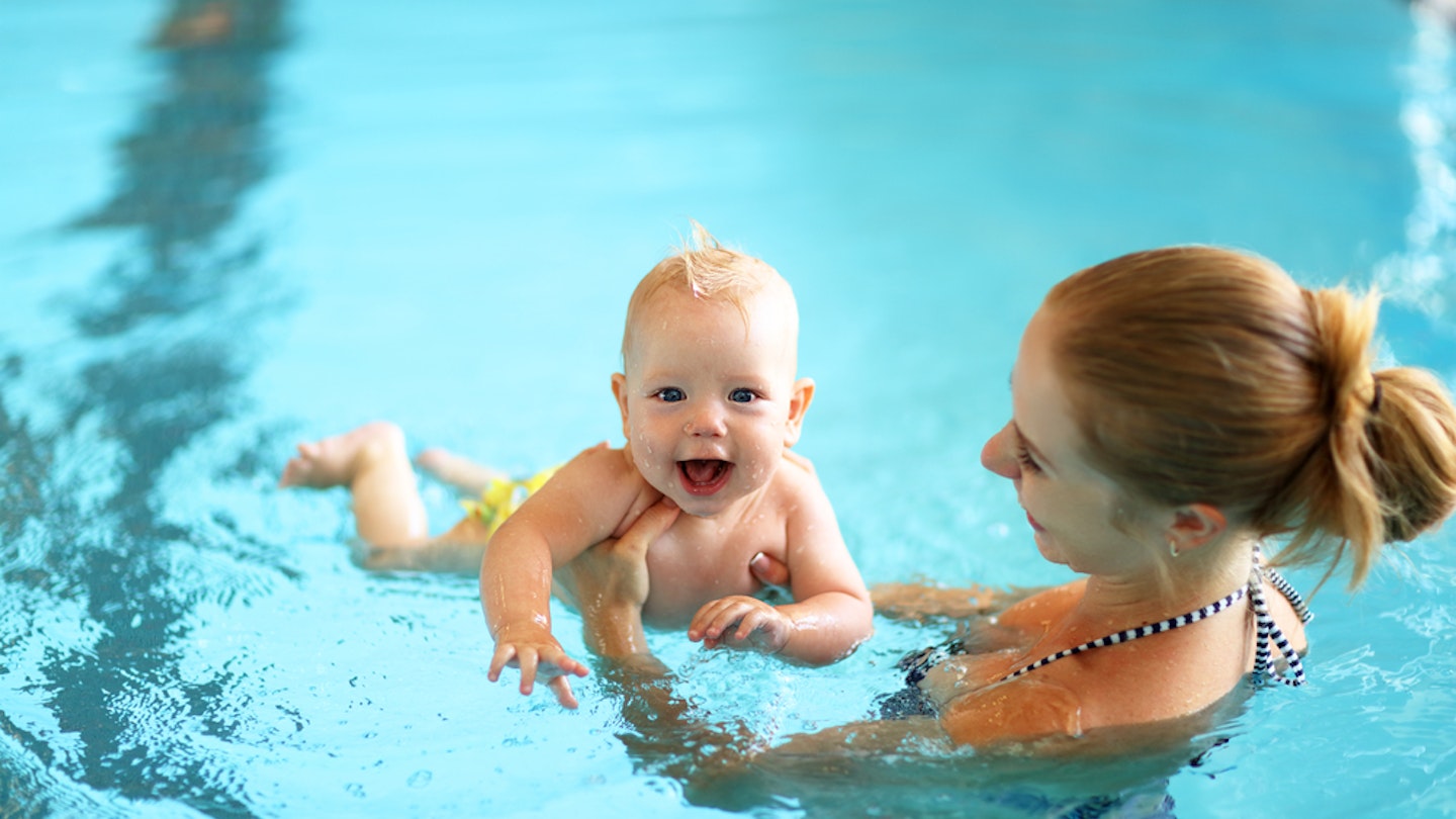 Baby swimming lesson with mum