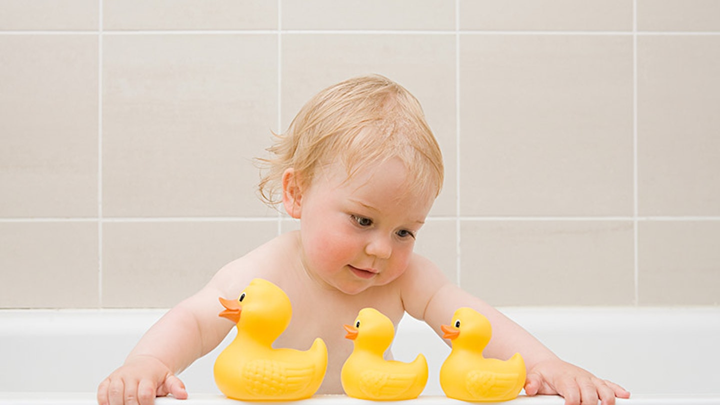 Baby with bath toys