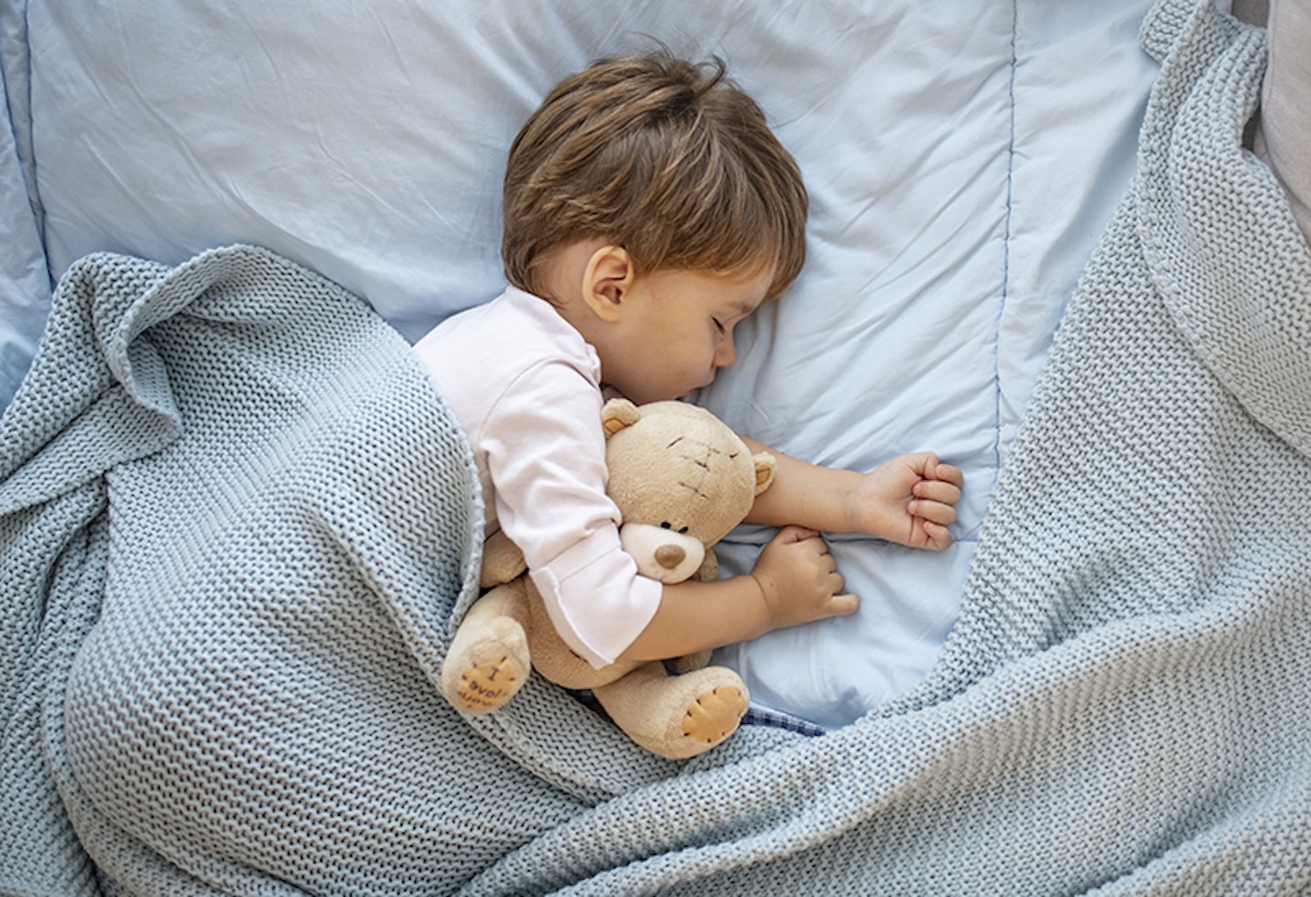 Toddler asleep in bed with teddy-Toddler Mattress