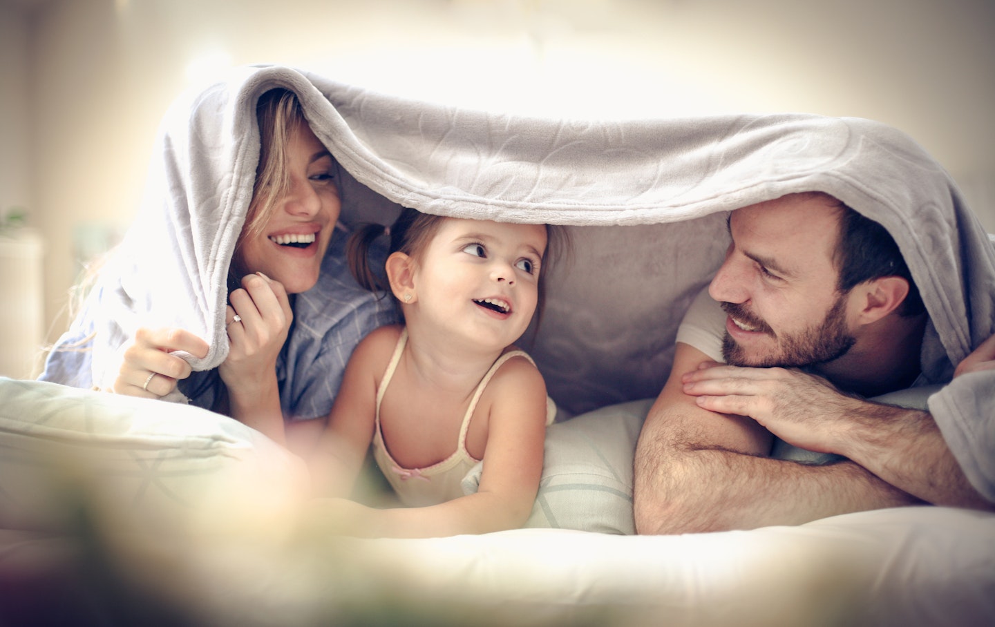 family playing in a den