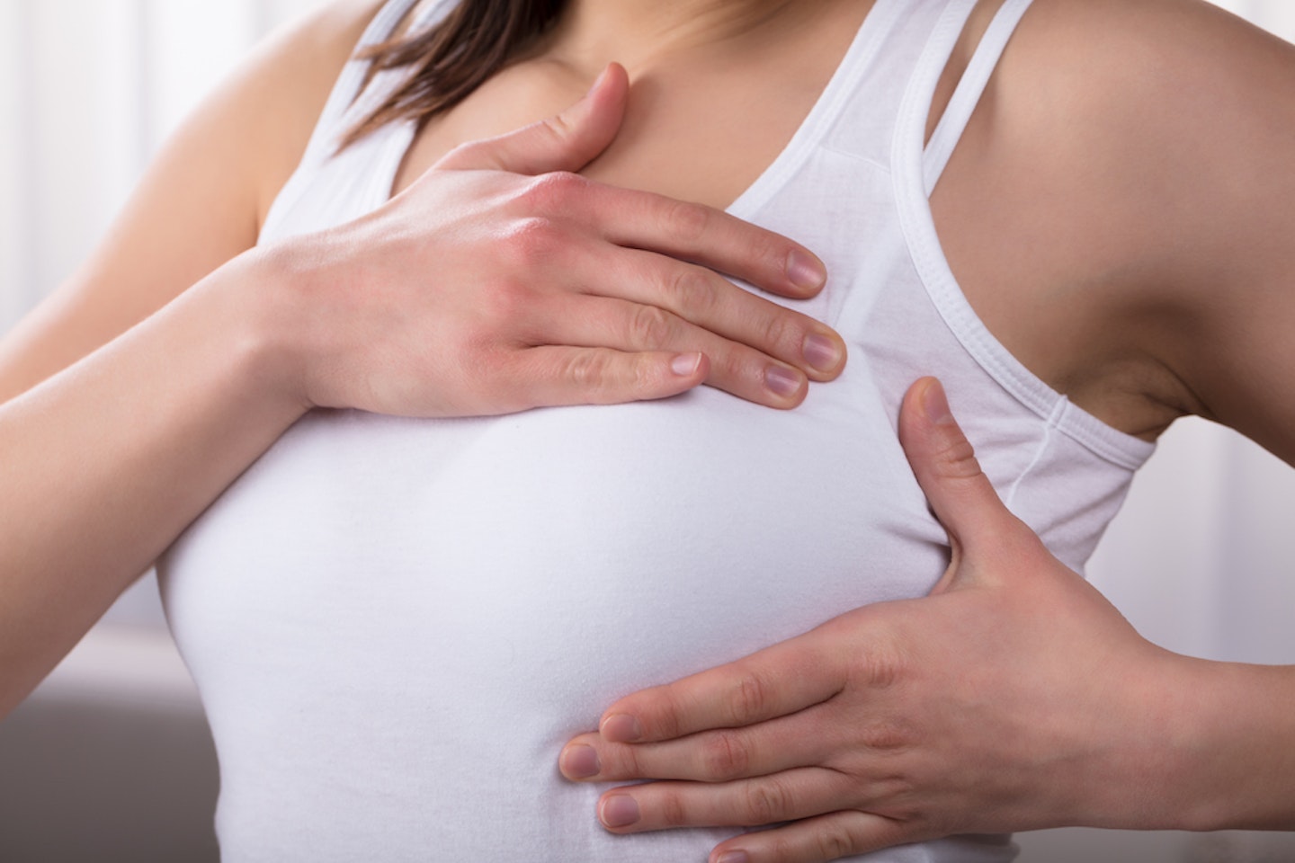 woman checking breasts