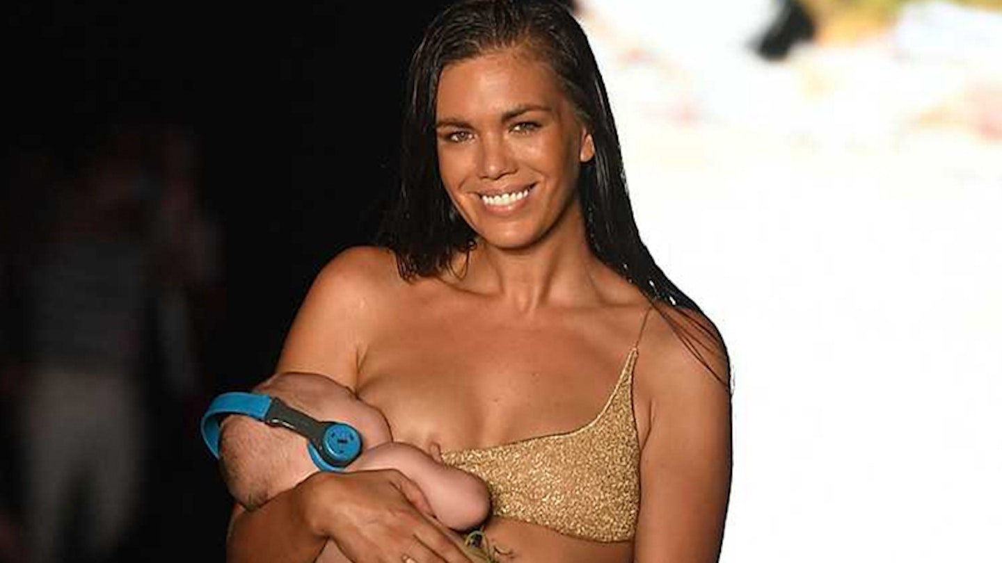 A model just walked the runway breastfeeding her baby and we couldn’t be more in awe