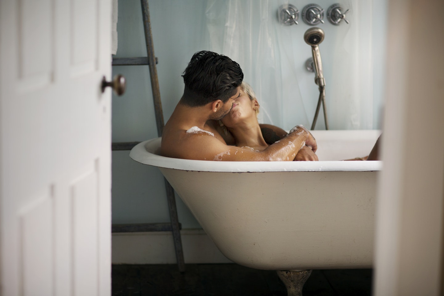 Couple kissing in bath