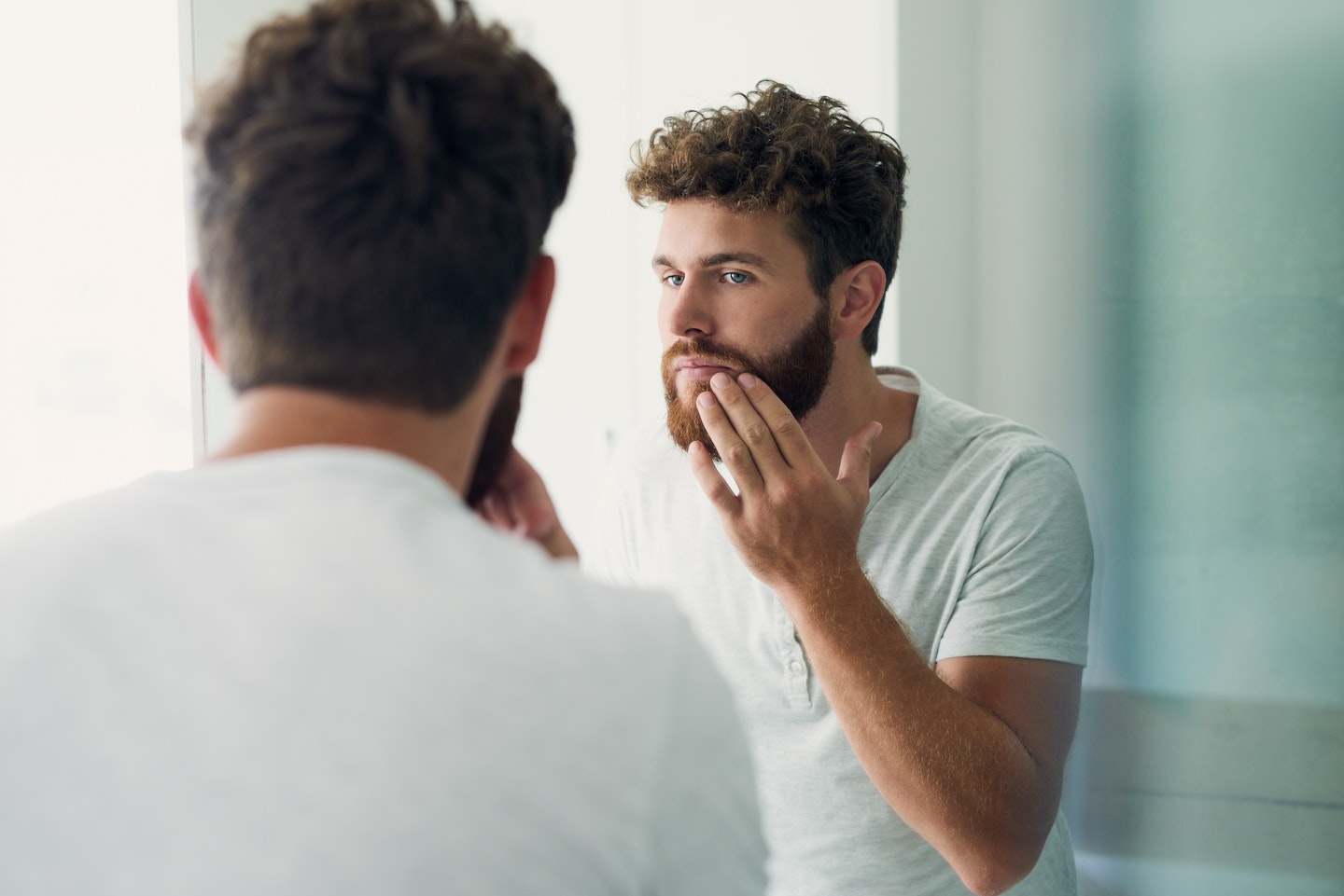 man looking in mirror