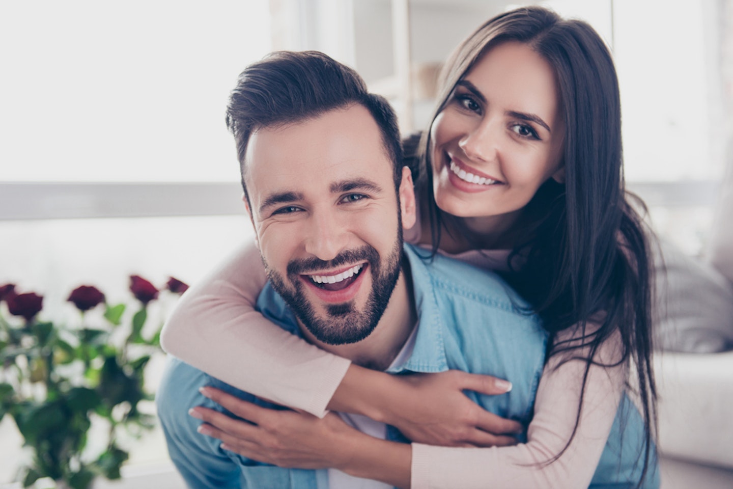 Woman hugging her partner from behind