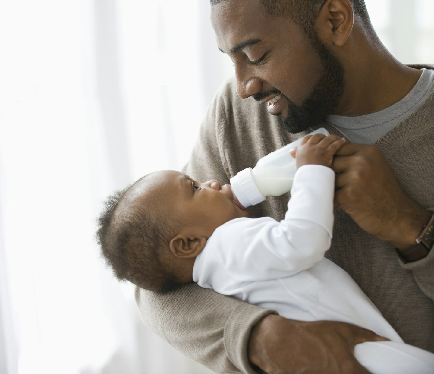 dad feeding baby