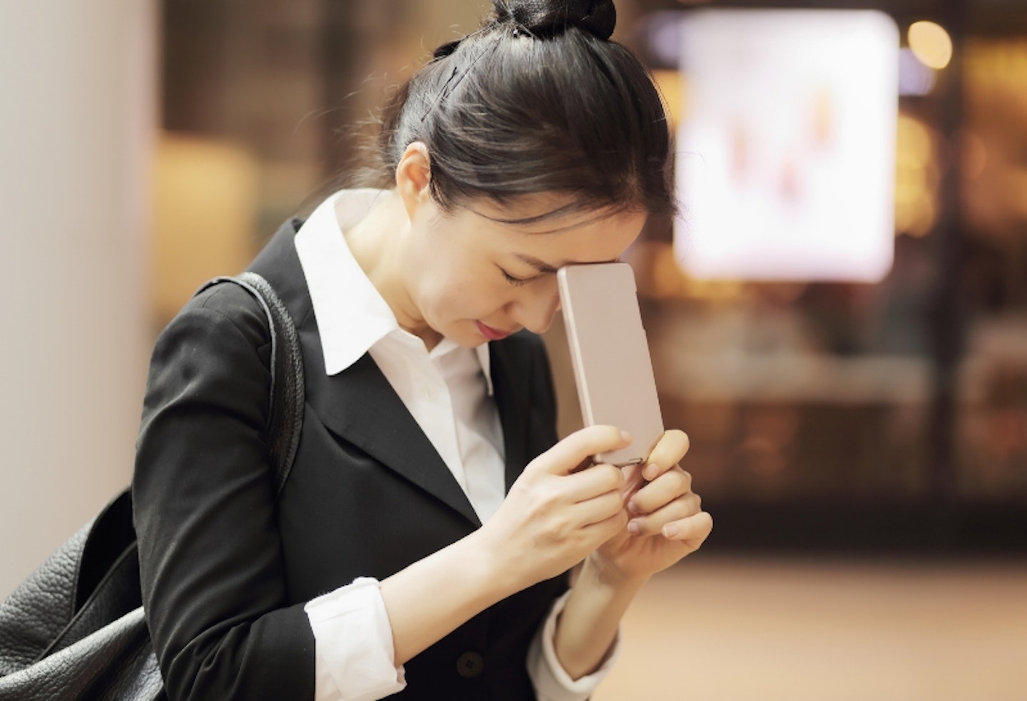 Stressed woman holding phone