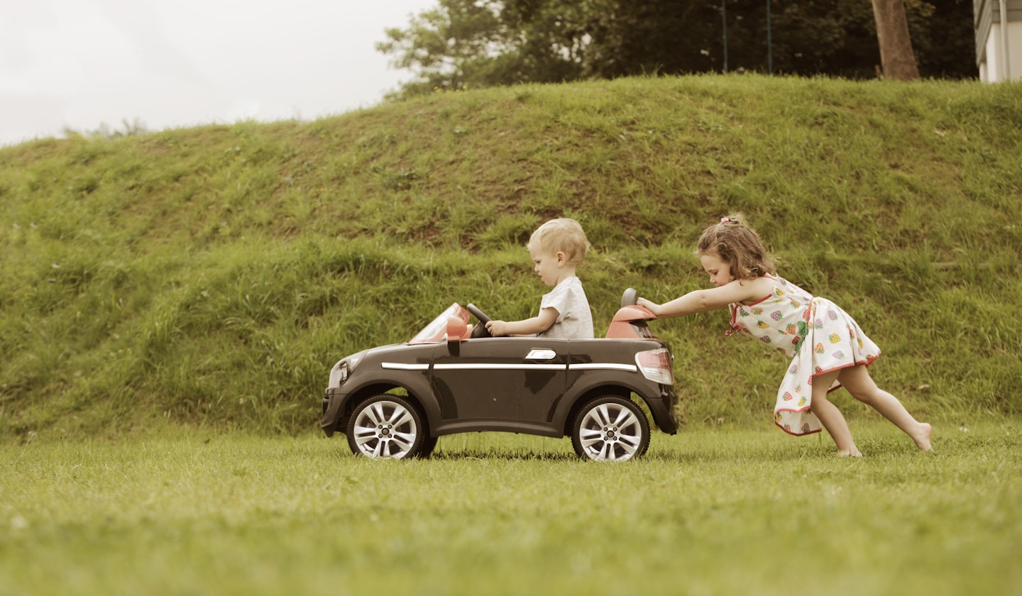 Children playing in toy car