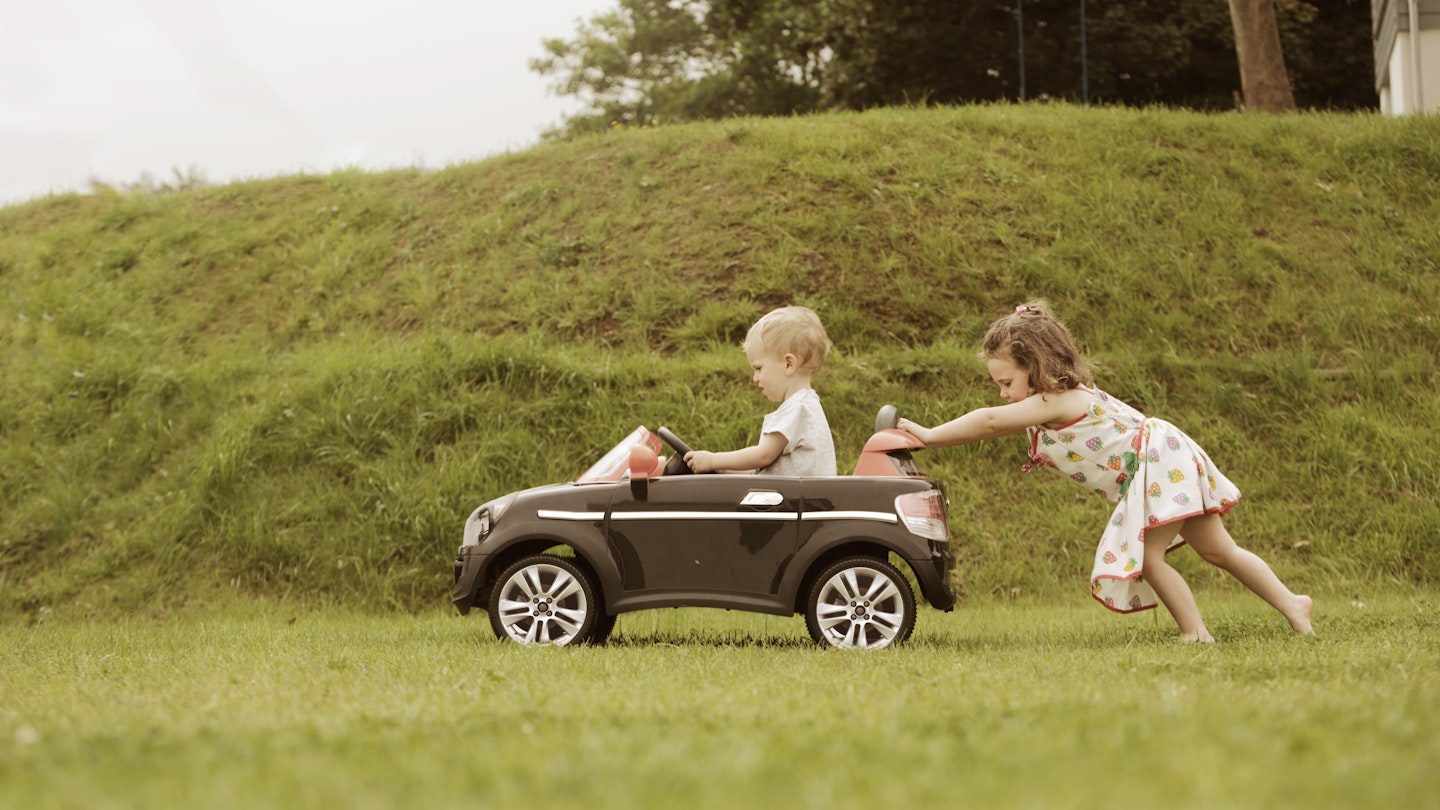Children playing in toy car