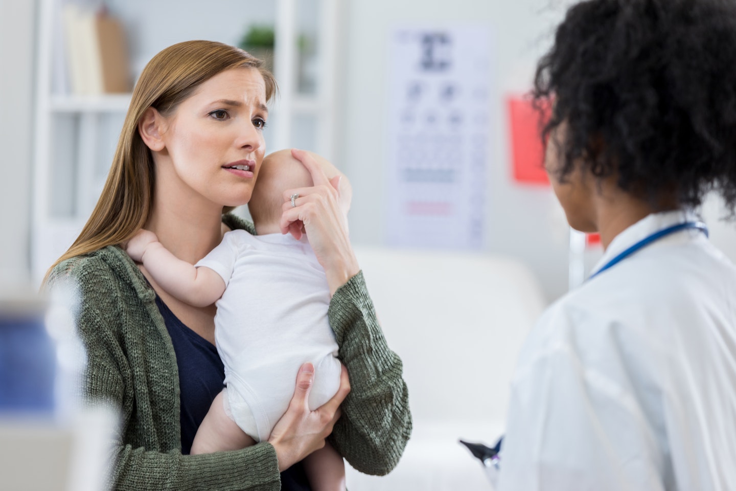 Mum holding baby at the doctors