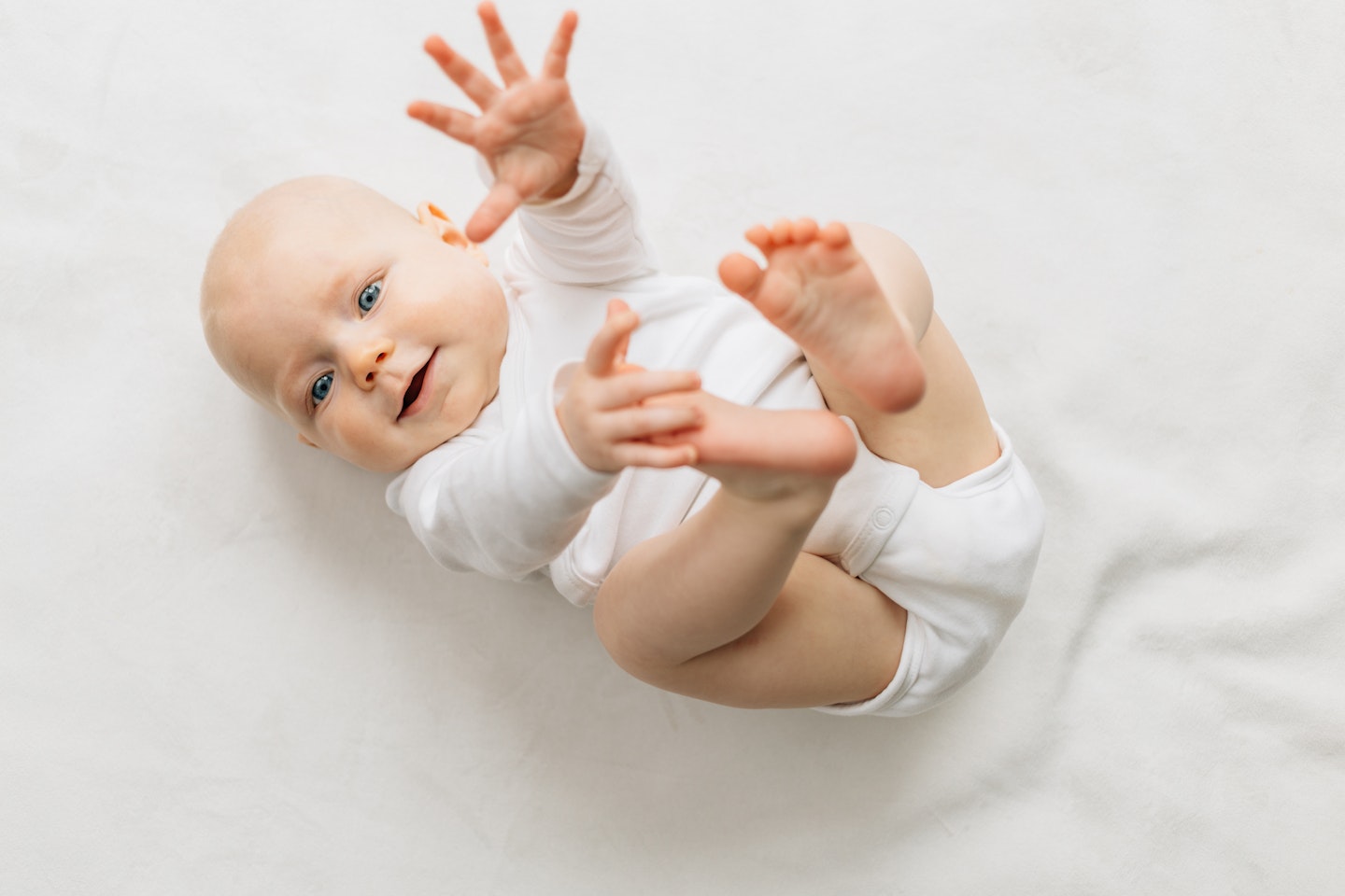 smiling baby reaching out with hands