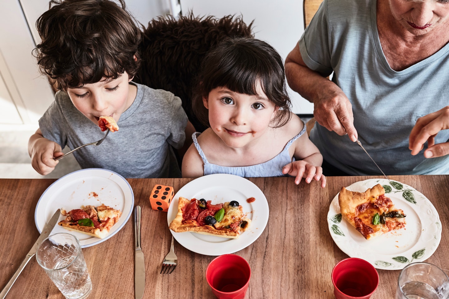 toddler smiling at dinner table