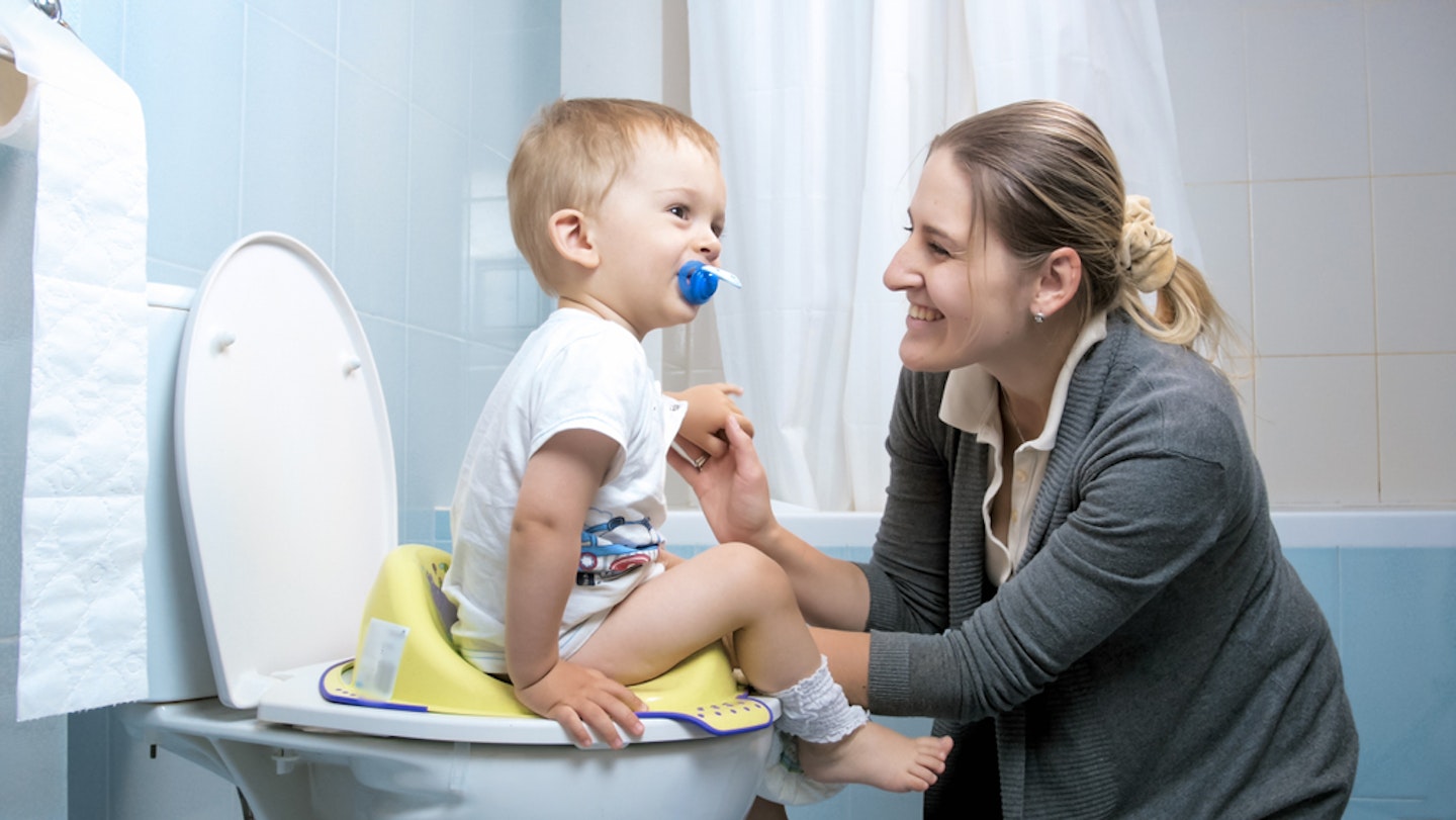 Mum encouraging toddler on the potty