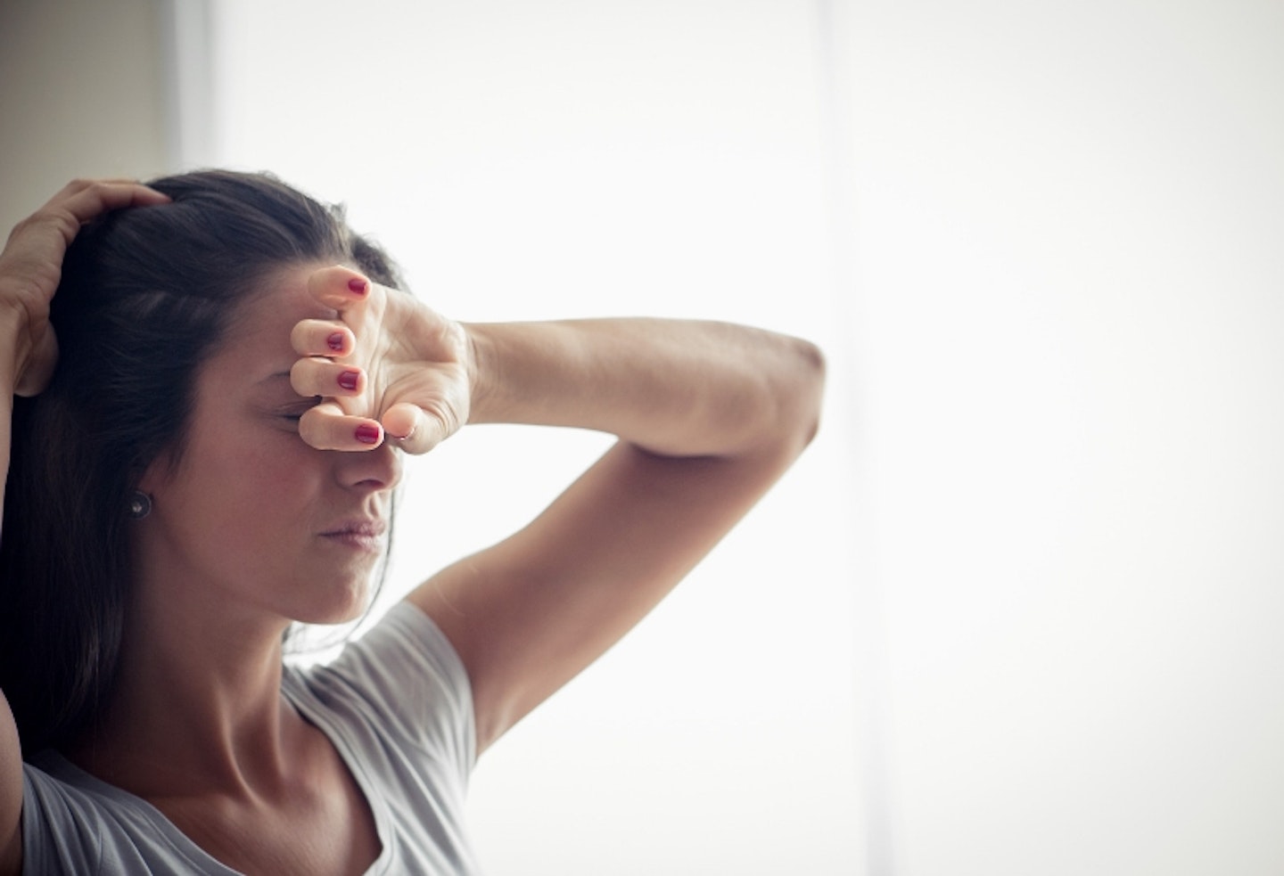 Woman wiping her brow